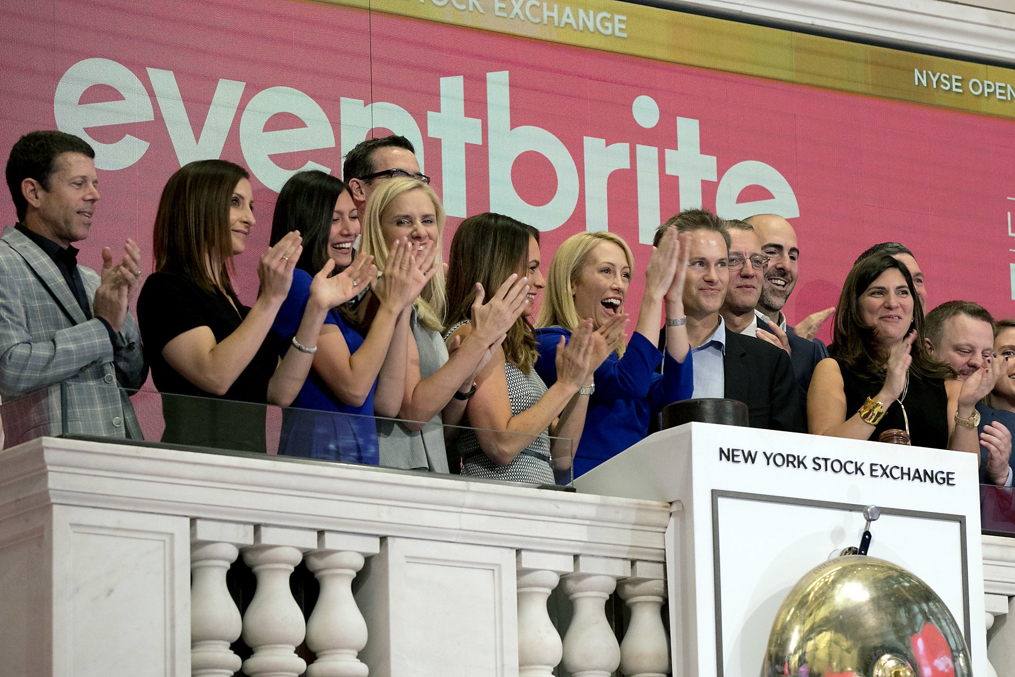 Julia Hartz, in blue, applauds with Kevin Hartz and Eventbrite colleagues at the New York Stock Exchange in September 2018