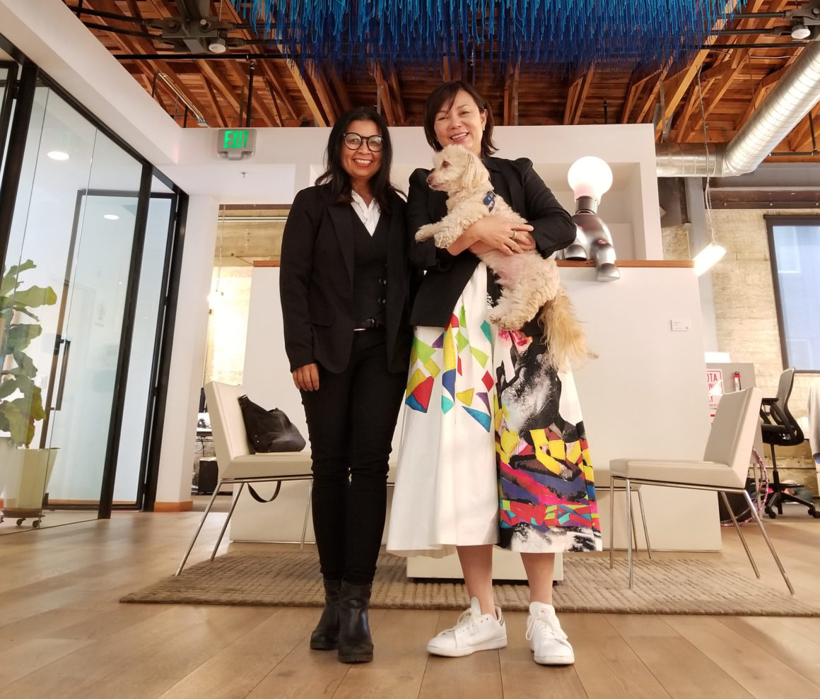 Ami Pascual Spear and Julia Huang, holding the company dog Renzei, inside Intertrend's office