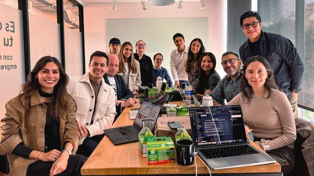 Julián Torres Gómez and Ontop’s leadership team gathered around a table with laptops