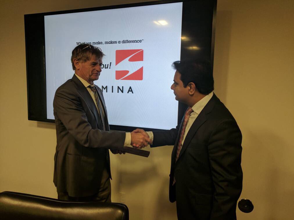 Jure Sola, at left, shakes hands with K. T. Rama Rao in a Sanmina meeting room.