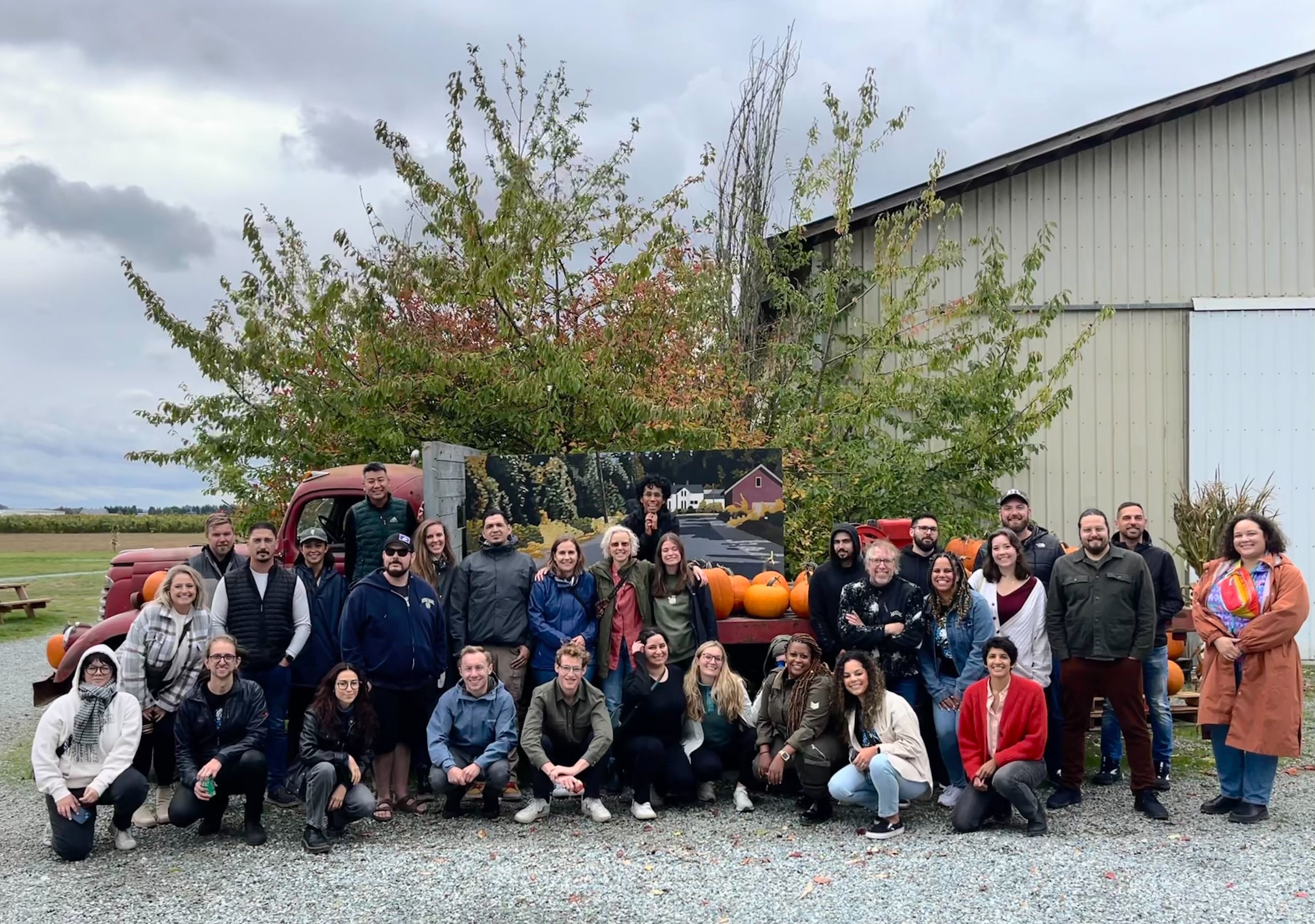 Justin Beals standing with the Strike Graph team outdoors near a pumpkin display