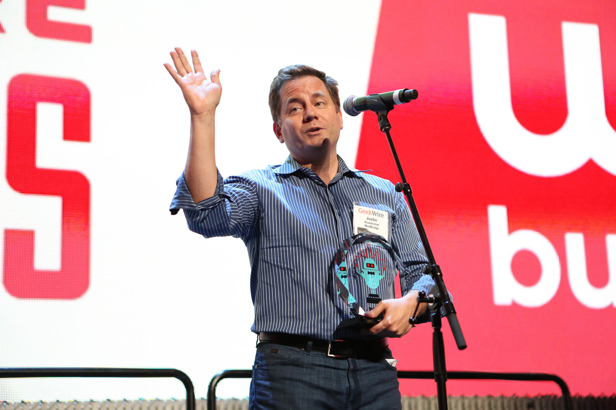 Justin Kowalchuk holding Medbridge’s Bootstrapper of the Year trophy at the 2016 GeekWire Awards