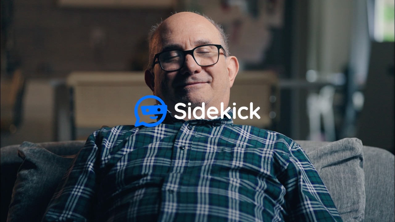 Still from Sidekick's official product video showing a man behind the Sidekick mark