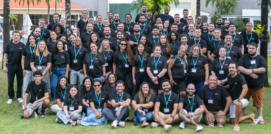 Juvo team members gathered outdoors wearing black Juvo shirts and turquoise lanyards