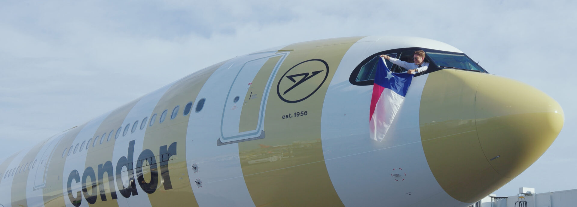 Condor Airlines pilot holding a Texas flag at the San Antonio launch