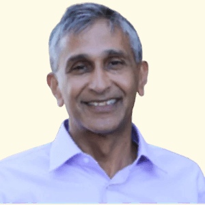 K. V. Rao smiling in a pale purple shirt