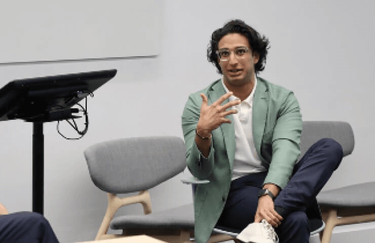 Kabir Barday seated and speaking during a conversation at IE University