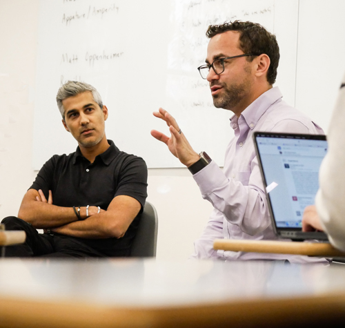 Kabir Shahani, left, listening as Matt Oppenheimer speaks in a University of Washington entrepreneurship class.