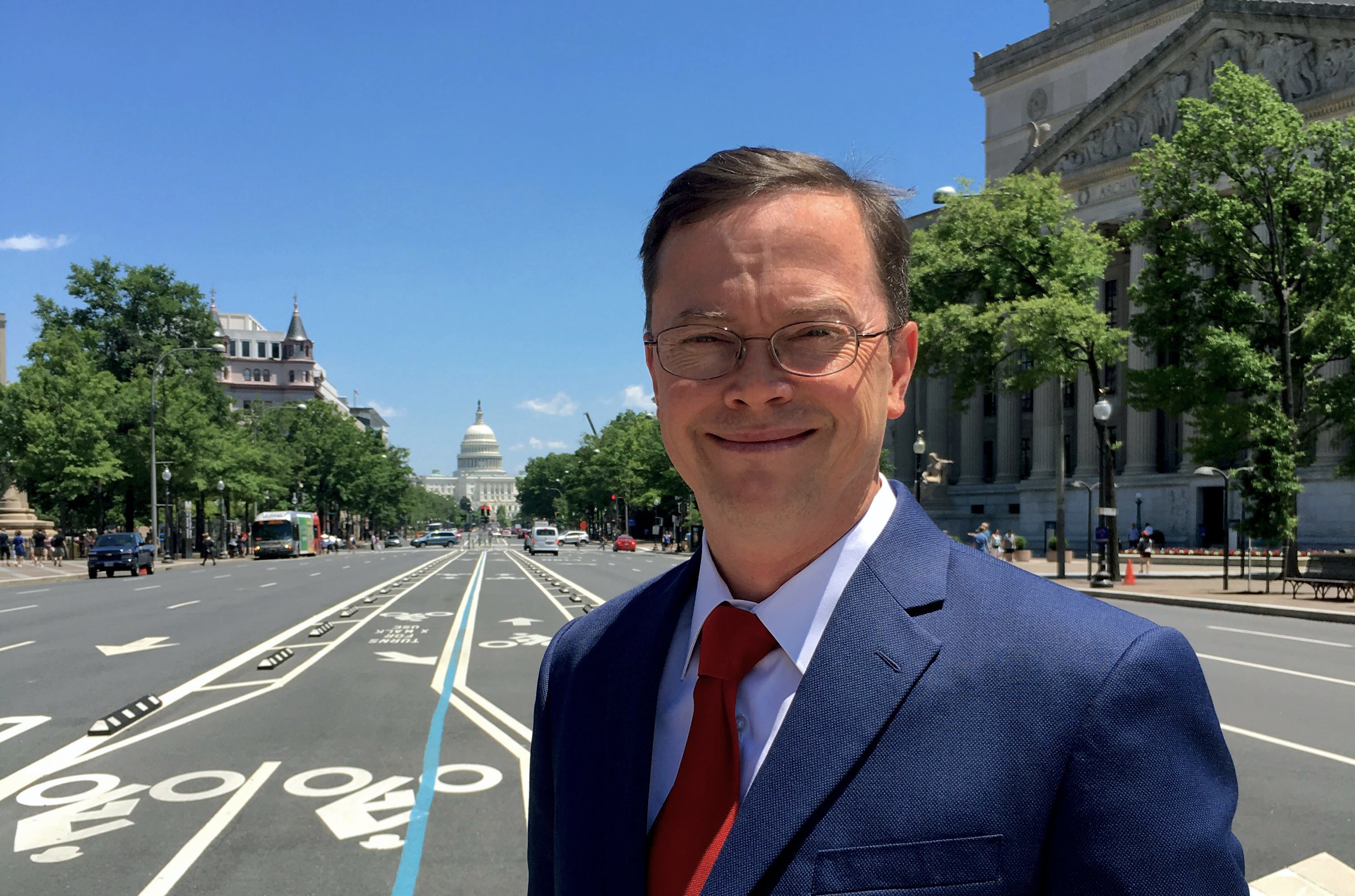 Kai Anderson on a Washington street with the United States Capitol behind him