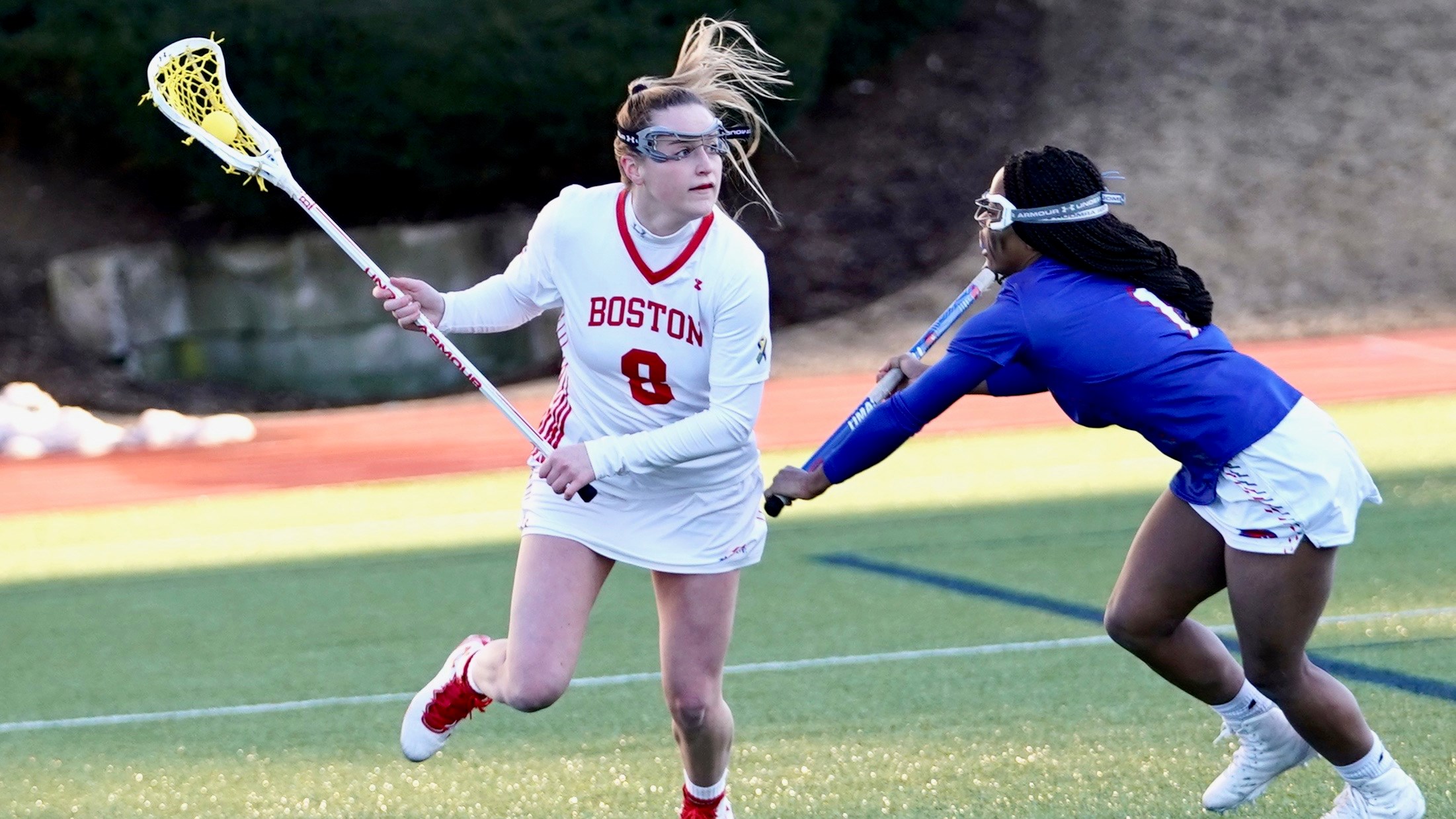 Kailey Conry carrying the ball for Boston University during a lacrosse game
