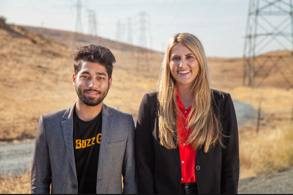 Buzz Solutions co-founders Vikhyat Chaudhry and Kaitlyn Albertoli standing near electrical transmission towers