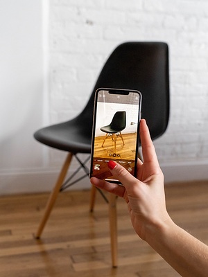 Kaiyo promotional photograph of a chair being photographed with a smartphone