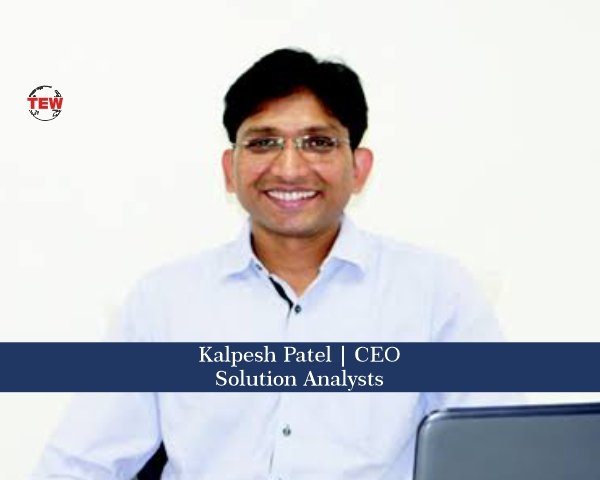 Kalpesh Patel seated at a desk with a laptop in a 2020 press photograph