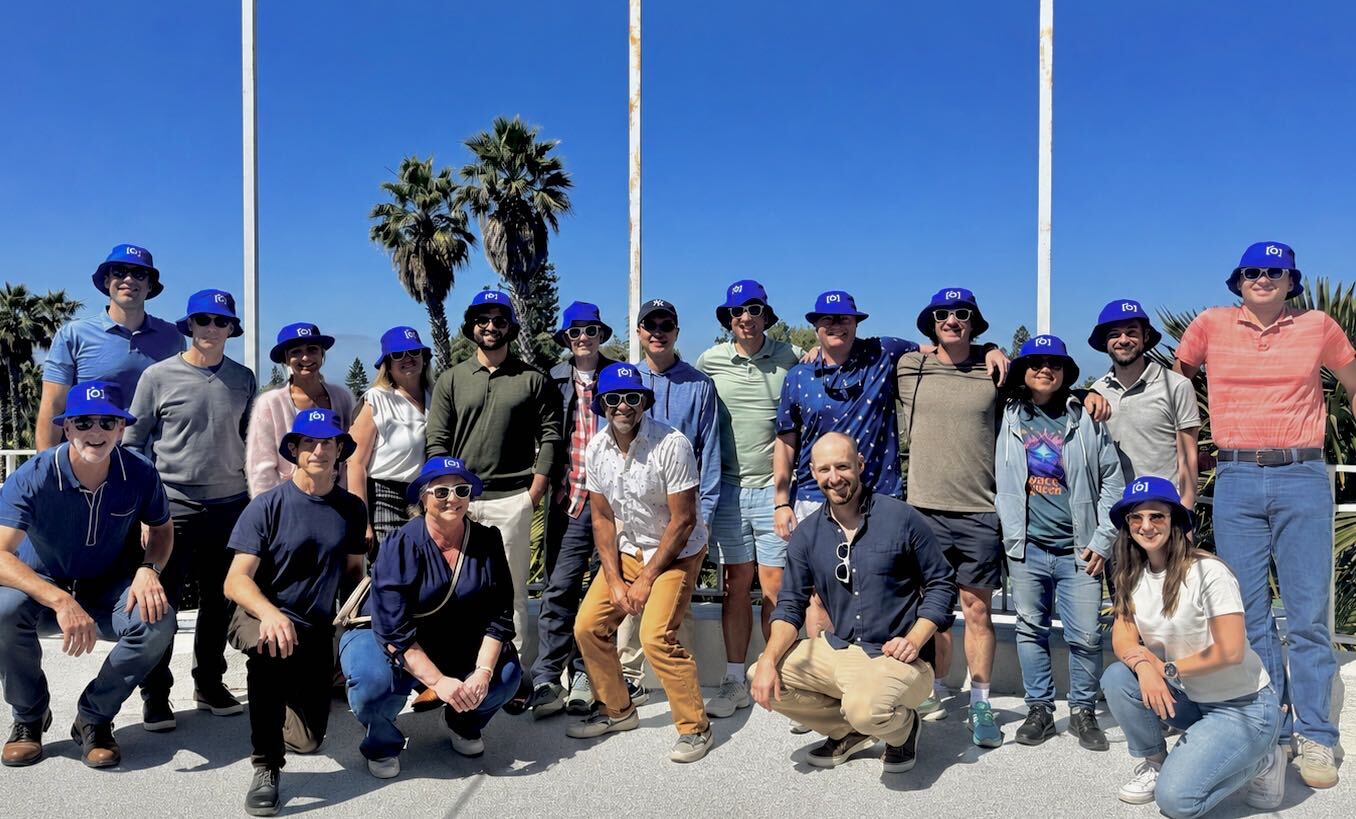 The SiteCapture team posing outdoors in blue company bucket hats