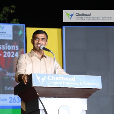 Kamalavel Rajendran speaking at a lectern during Chettinad College’s 2024 College and Placement Day