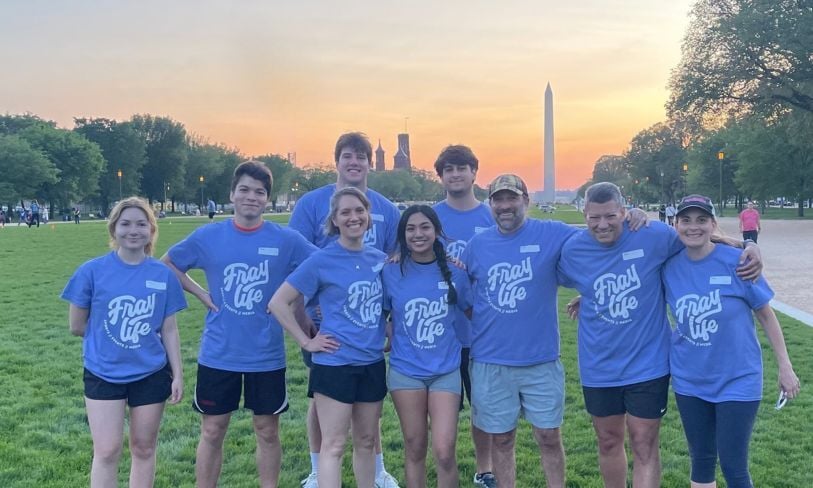Kaptivate team members in matching blue shirts on the National Mall with the Washington Monument behind them