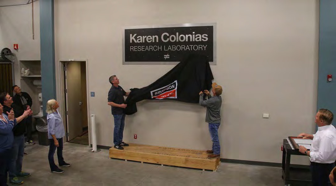 The Karen Colonias Research Laboratory sign is unveiled before colleagues in Pleasanton