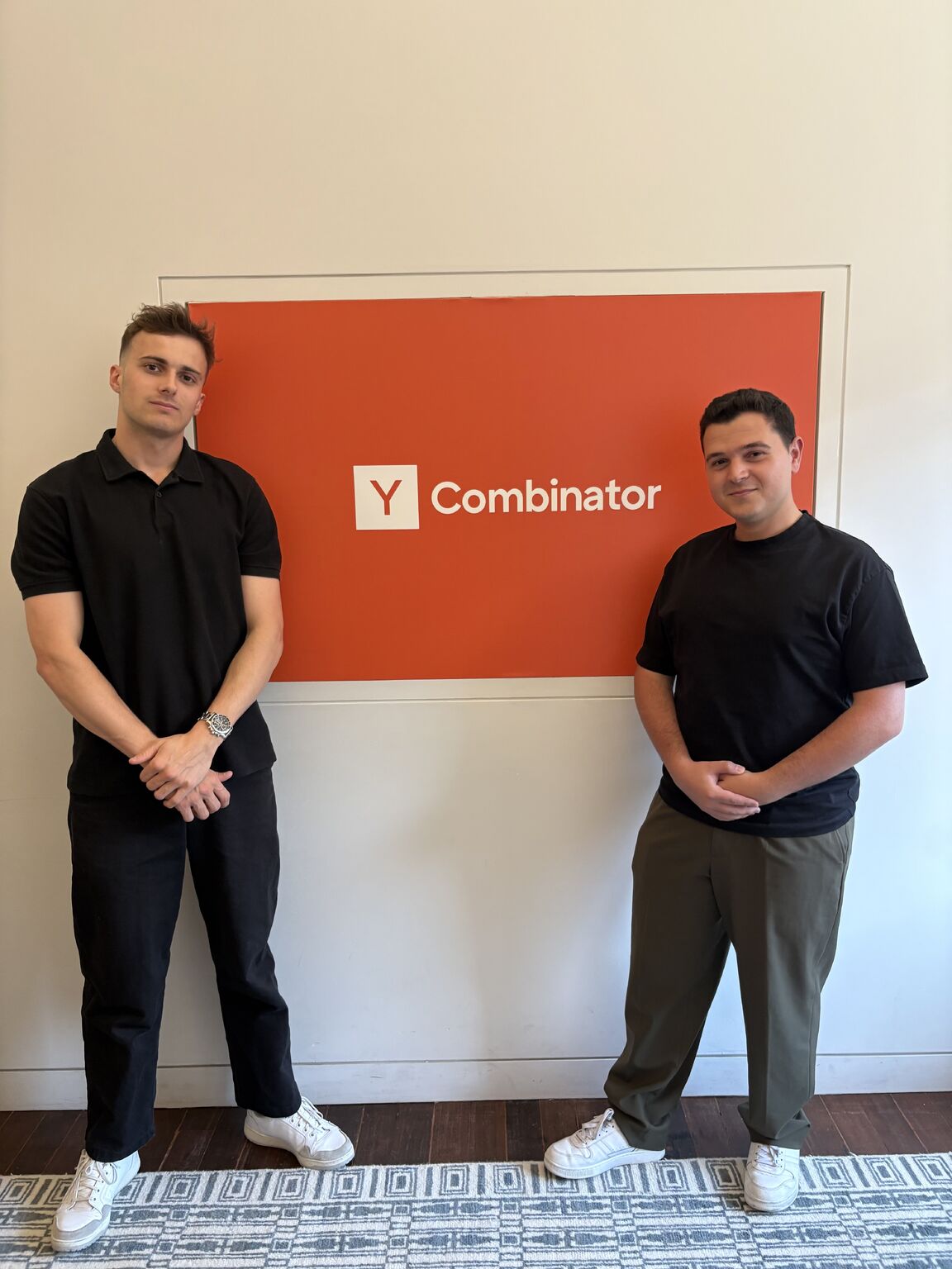 Pierre Depuydt and Karim Bouri standing beside a Y Combinator sign