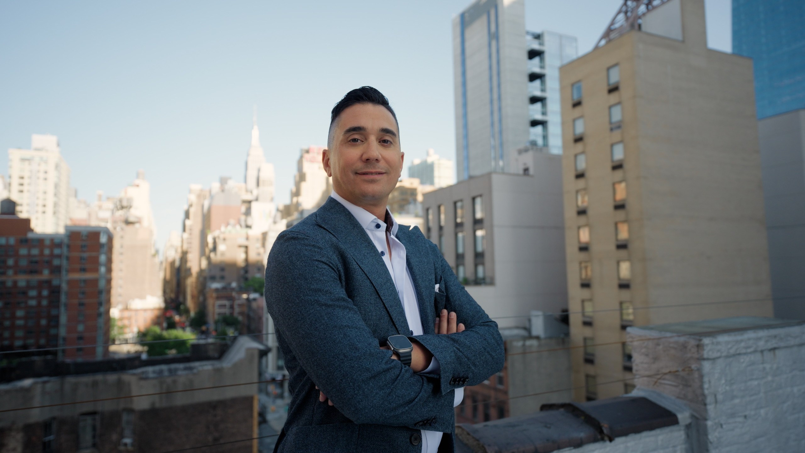 Karim Galil standing outdoors against a city skyline