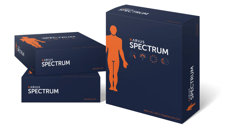 Karius Spectrum test kit boxes in the company's navy and orange branding