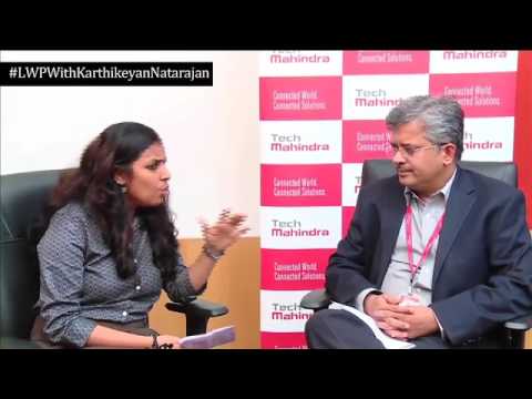 Karthikeyan Natarajan speaking with an interviewer in a Tech Mahindra leadership conversation in 2017