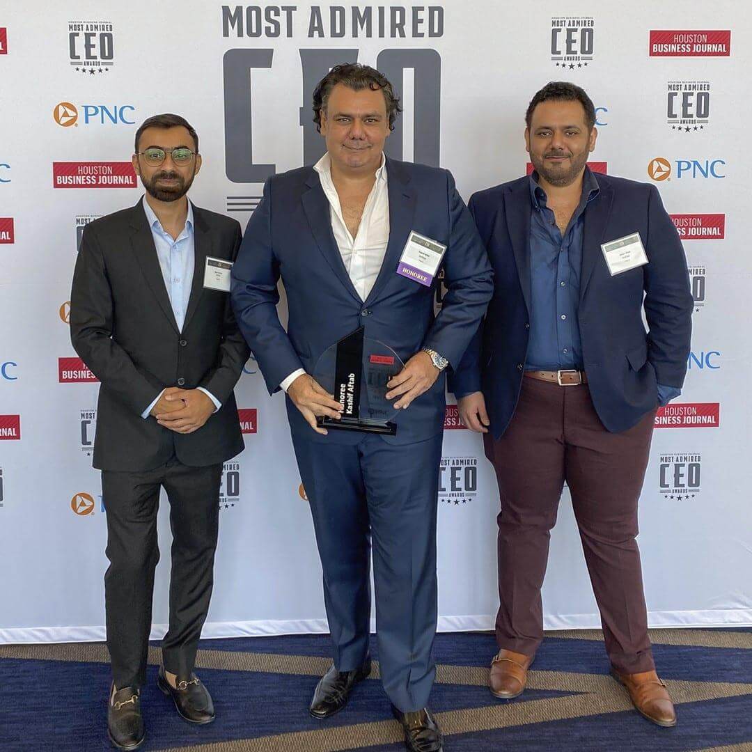 Kashif Aftab, center, holding his award at the Houston Business Journal Most Admired CEO event