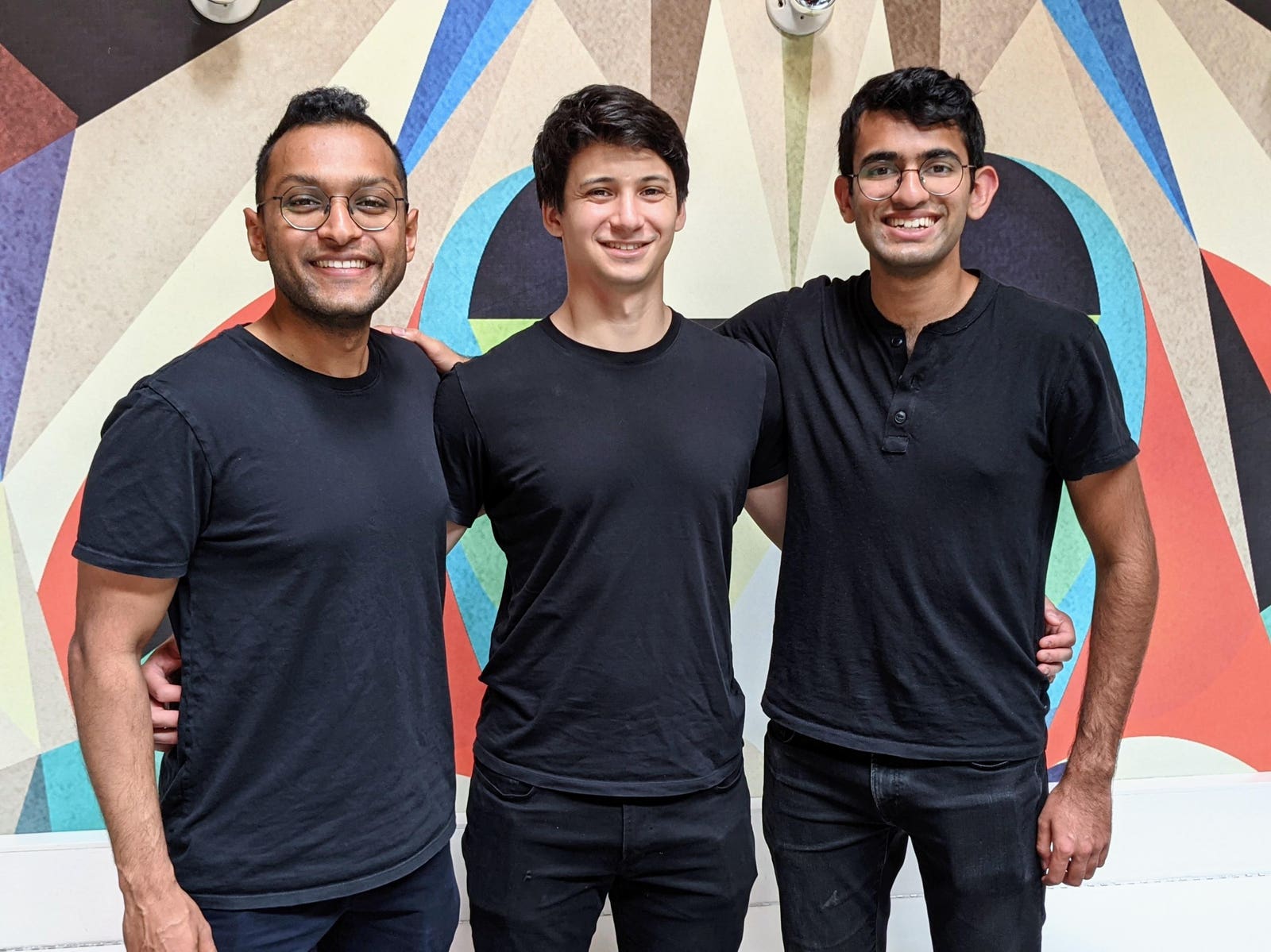 Hightouch co-founders Kashish Gupta, Joshua Curl, and Tejas Manohar standing together in front of a geometric mural