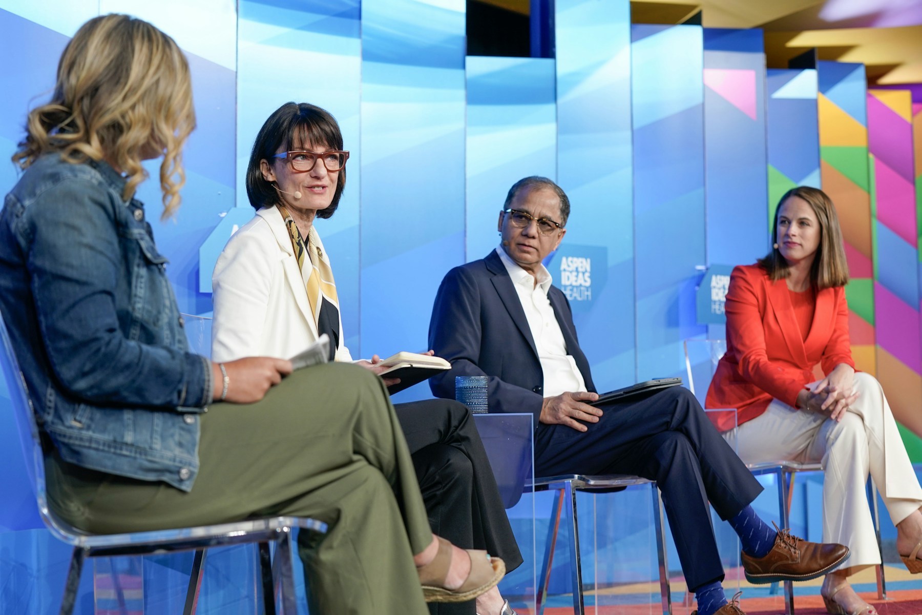 Katie Drasser, at left, seated with three fellow speakers on an Aspen Ideas stage in 2025