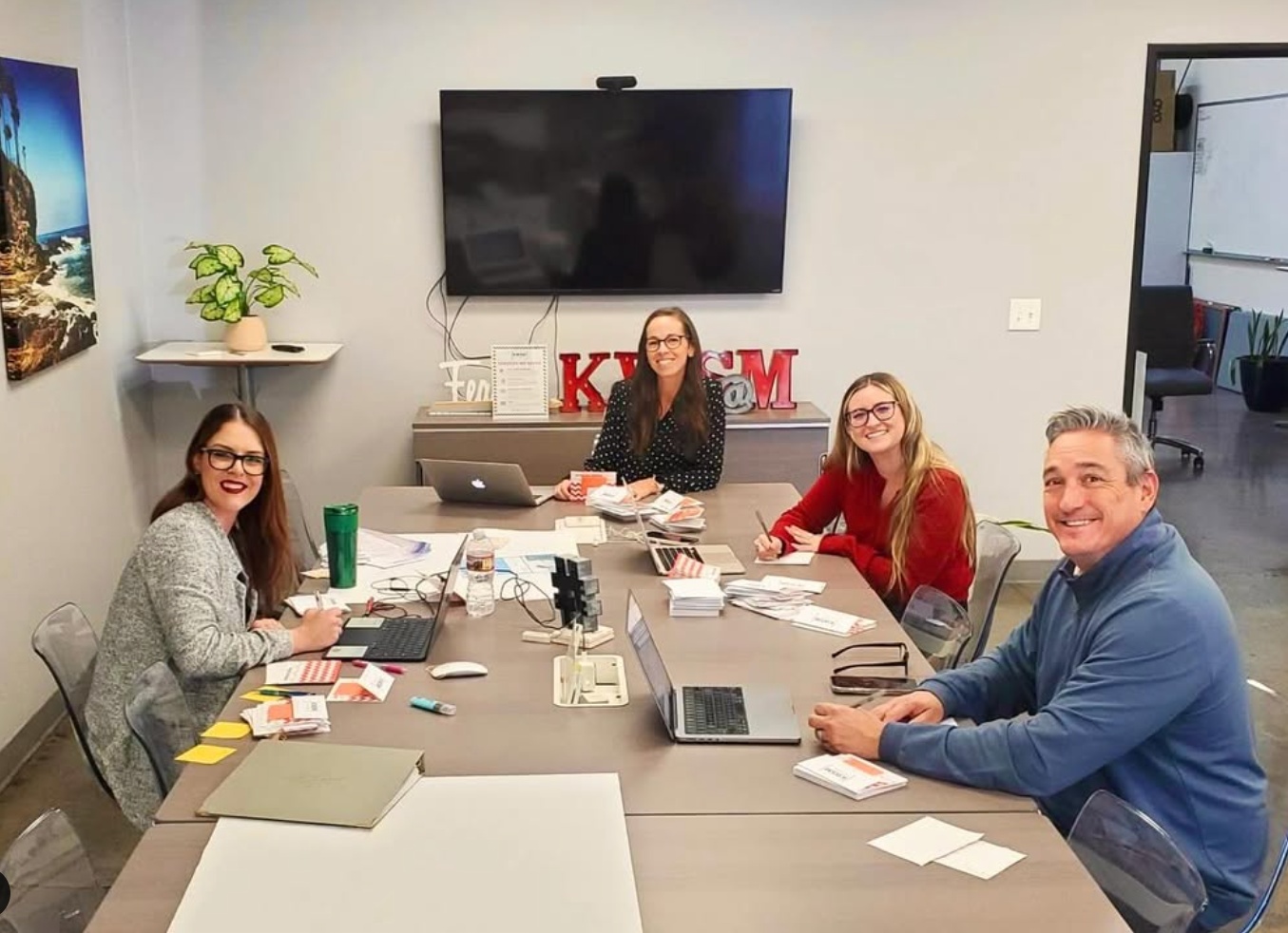 Katie Wagner and colleagues seated around a KWSM conference table