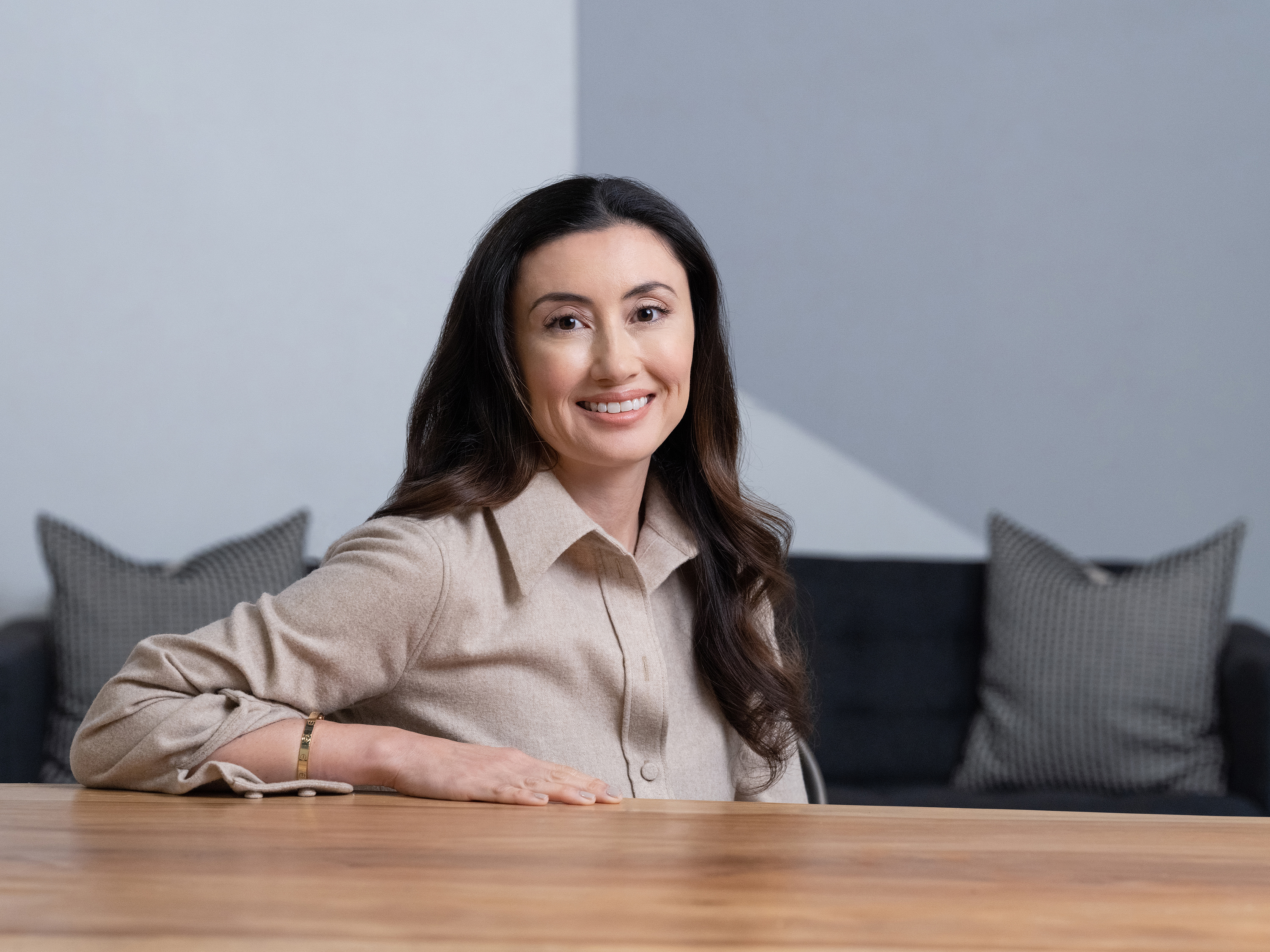 Katrina Lake seated at a table, photographed for Recruit Holdings