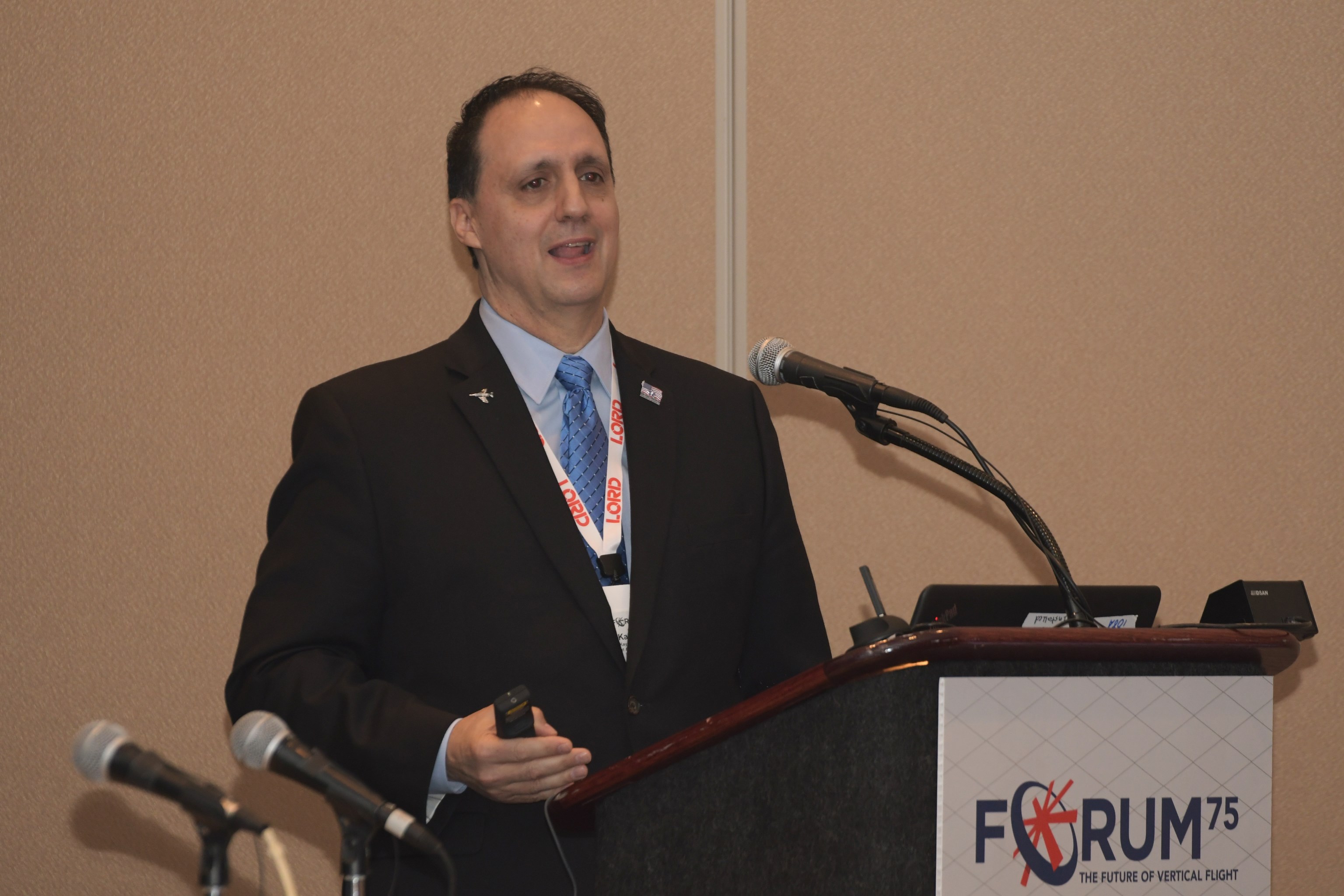 Kaydon Stanzione speaking at a lectern during the 2019 Vertical Flight Society Forum 75