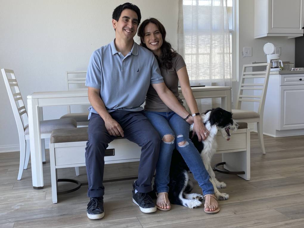 Residents and their dog in a kitchen, photographed for a report on KB Home’s Menifee microgrid communities