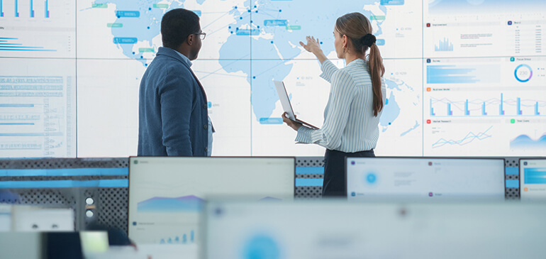 People collaborating around a table in KBX’s freight-management photograph