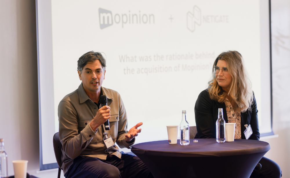 Kees Wolters speaking beside Netigate CEO Maria Börjesson at Mopinion Connects 2025