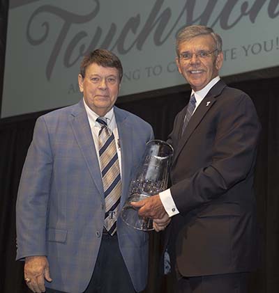 Keith Busse, left, receiving Trine University's Pillar of Success award from Earl D. Brooks II in 2021