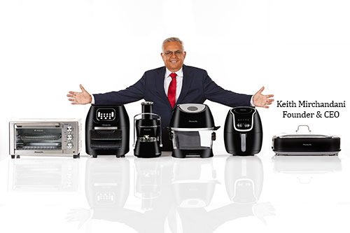 Keith Mirchandani standing behind a display of Tristar countertop appliances