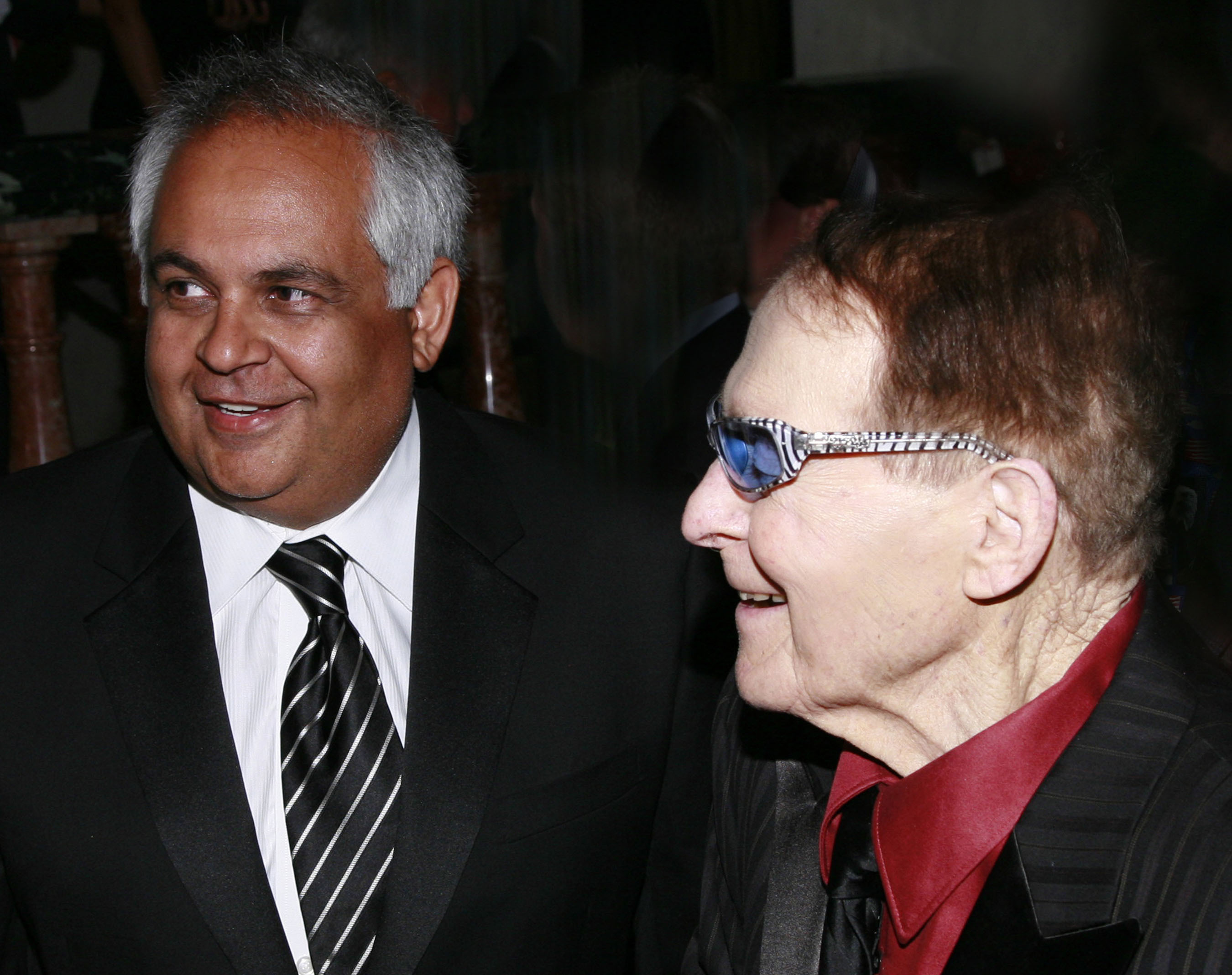 Keith Mirchandani, left, smiling beside Jack LaLanne at an event