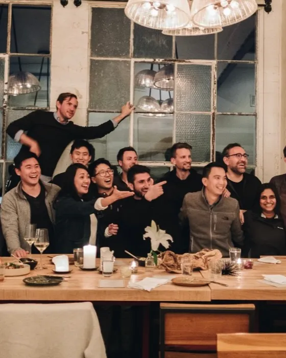 A group of founders seated around a table at a Y Combinator Growth dinner
