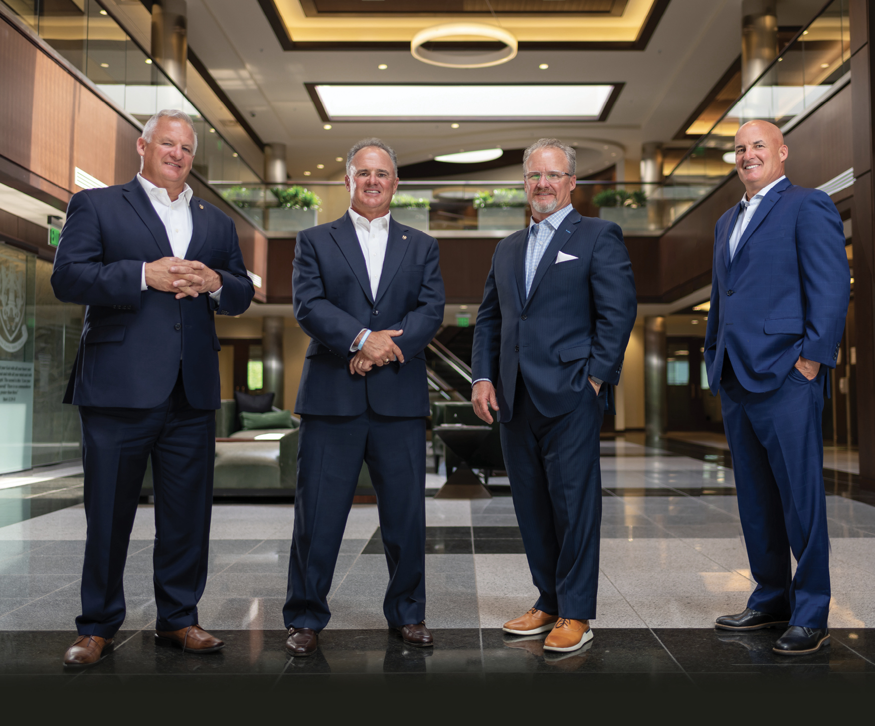 David Kelly, Frank Kelly III, John Kelly and Bryan Kelly standing in the company office