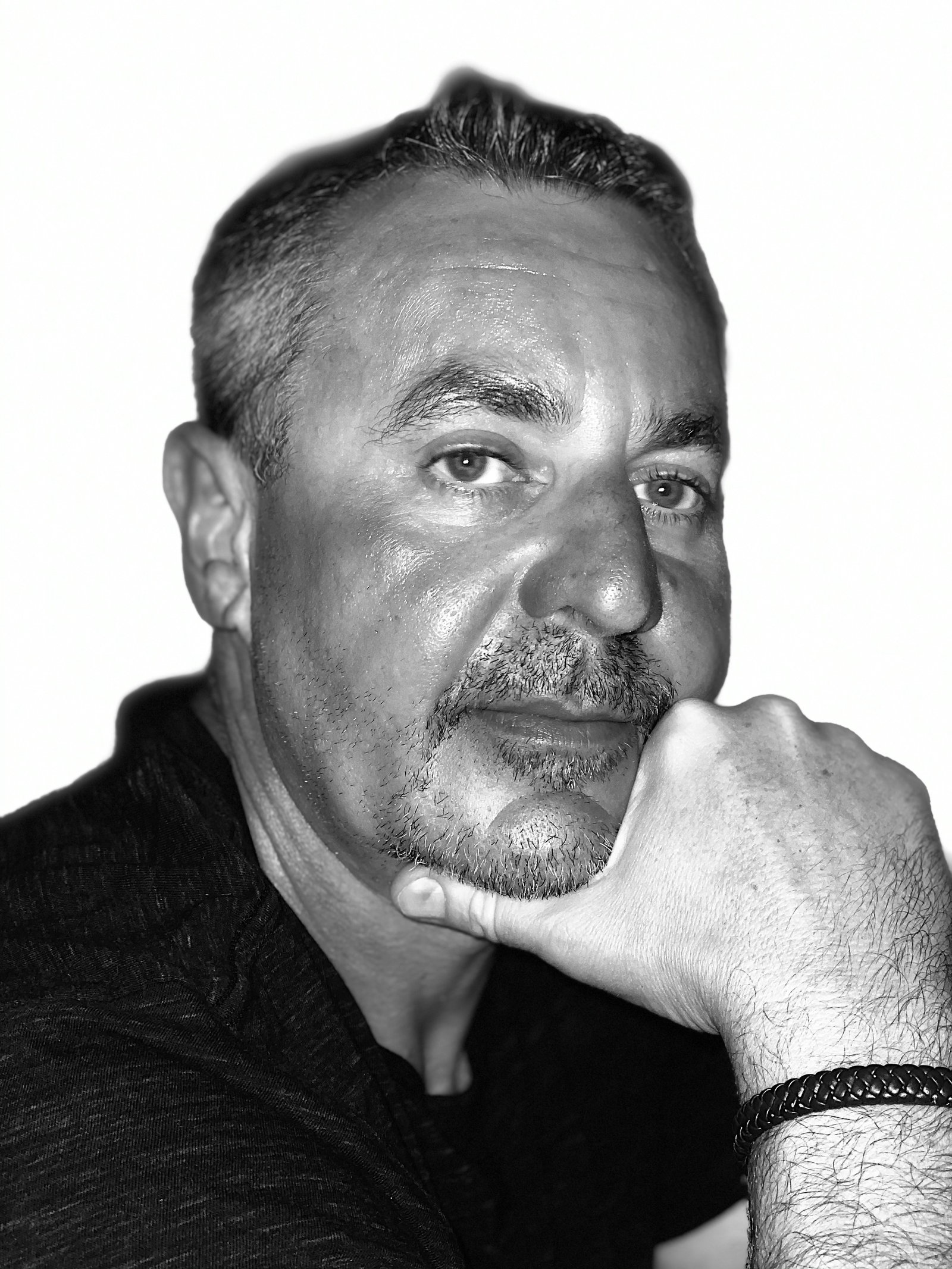 Black-and-white photograph of Kelly Robinson resting his chin on his hand