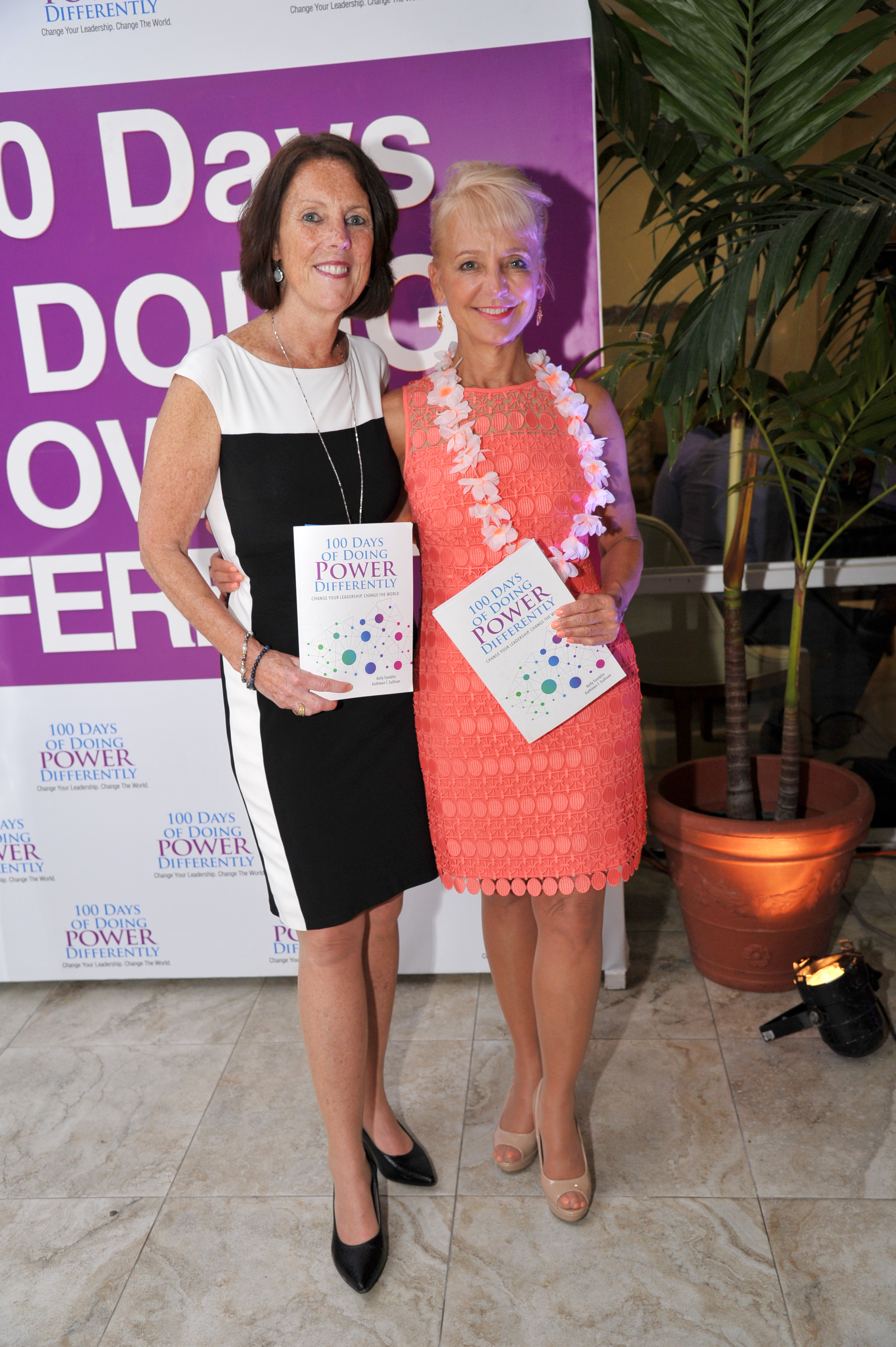 Kathleen Sullivan and Kelly Tomblin holding their leadership books at the Jamaica launch