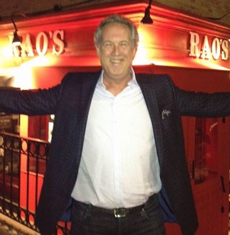 Ken Gross with his arms outstretched in front of Rao’s