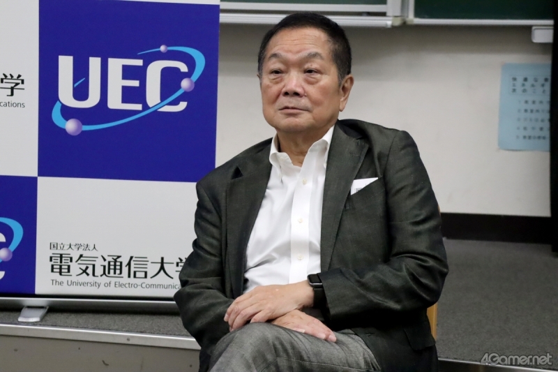 Ken Kutaragi seated in a suit at the University of Electro-Communications
