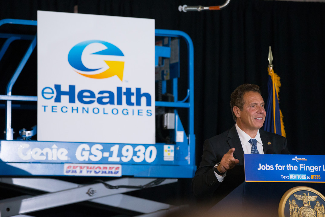 Governor Andrew Cuomo speaking beside an eHealth Technologies sign during his 2017 company visit