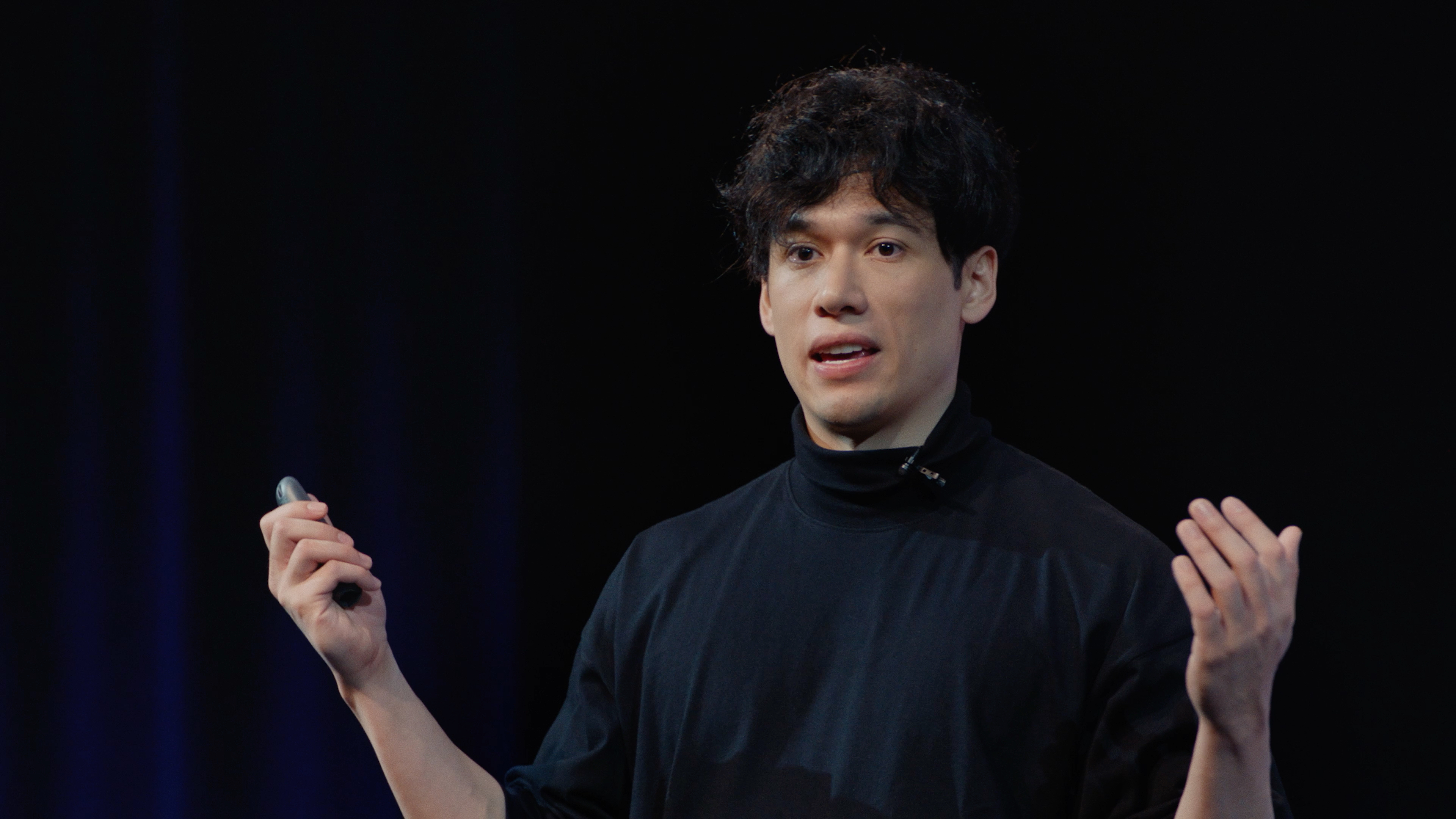 Kennan Davison presenting at Icon Keynote 2026, holding a clicker