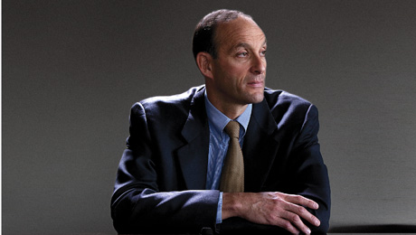 Kenneth Jacobs seated in a suit, looking to the side