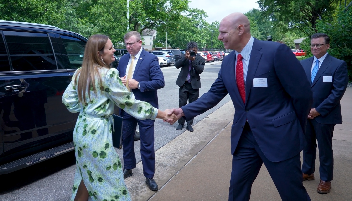 Kenny Gunderman greeting a guest outside Uniti at its 2024 merger announcement event