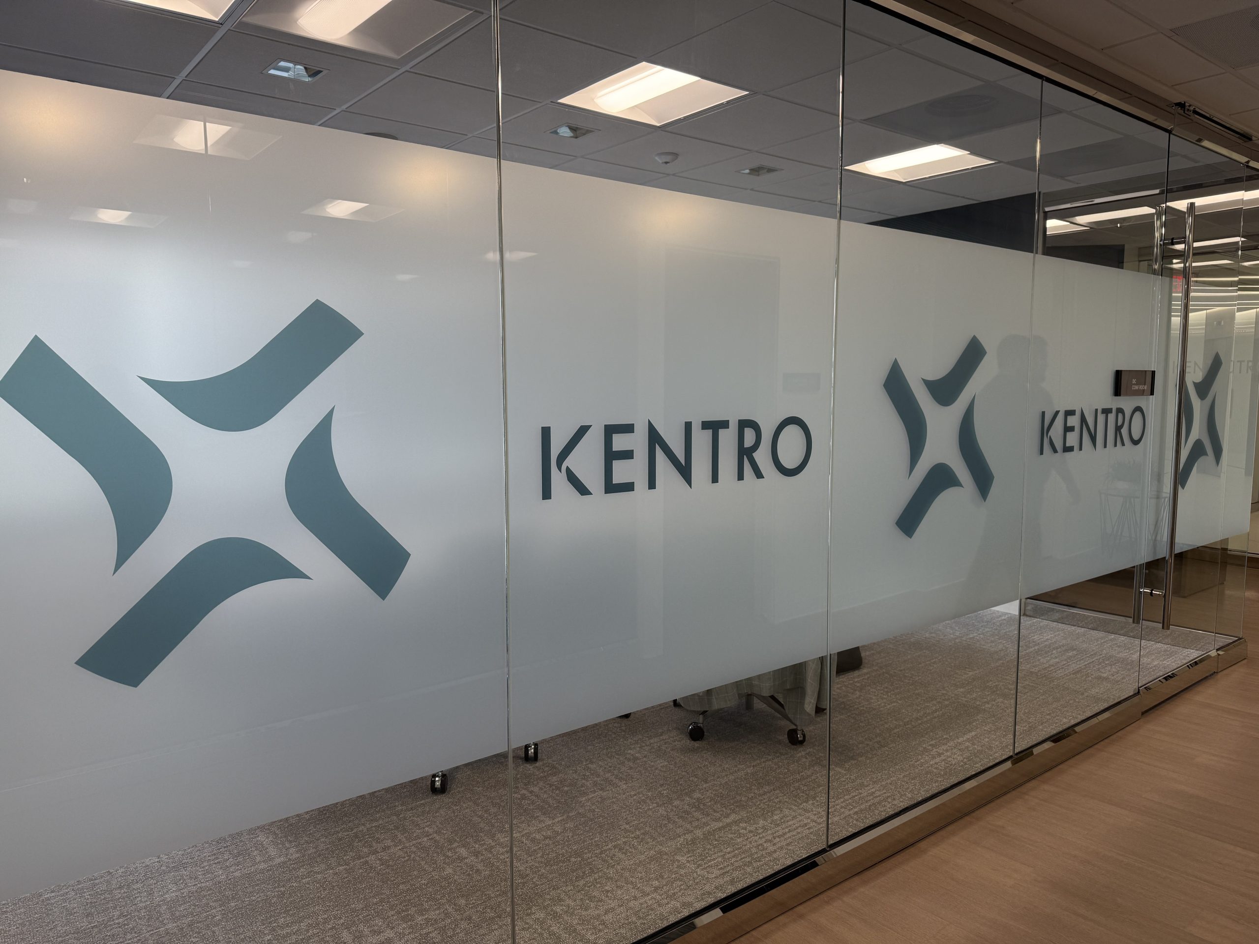Glass-walled rooms with Kentro lettering at the company’s McLean office