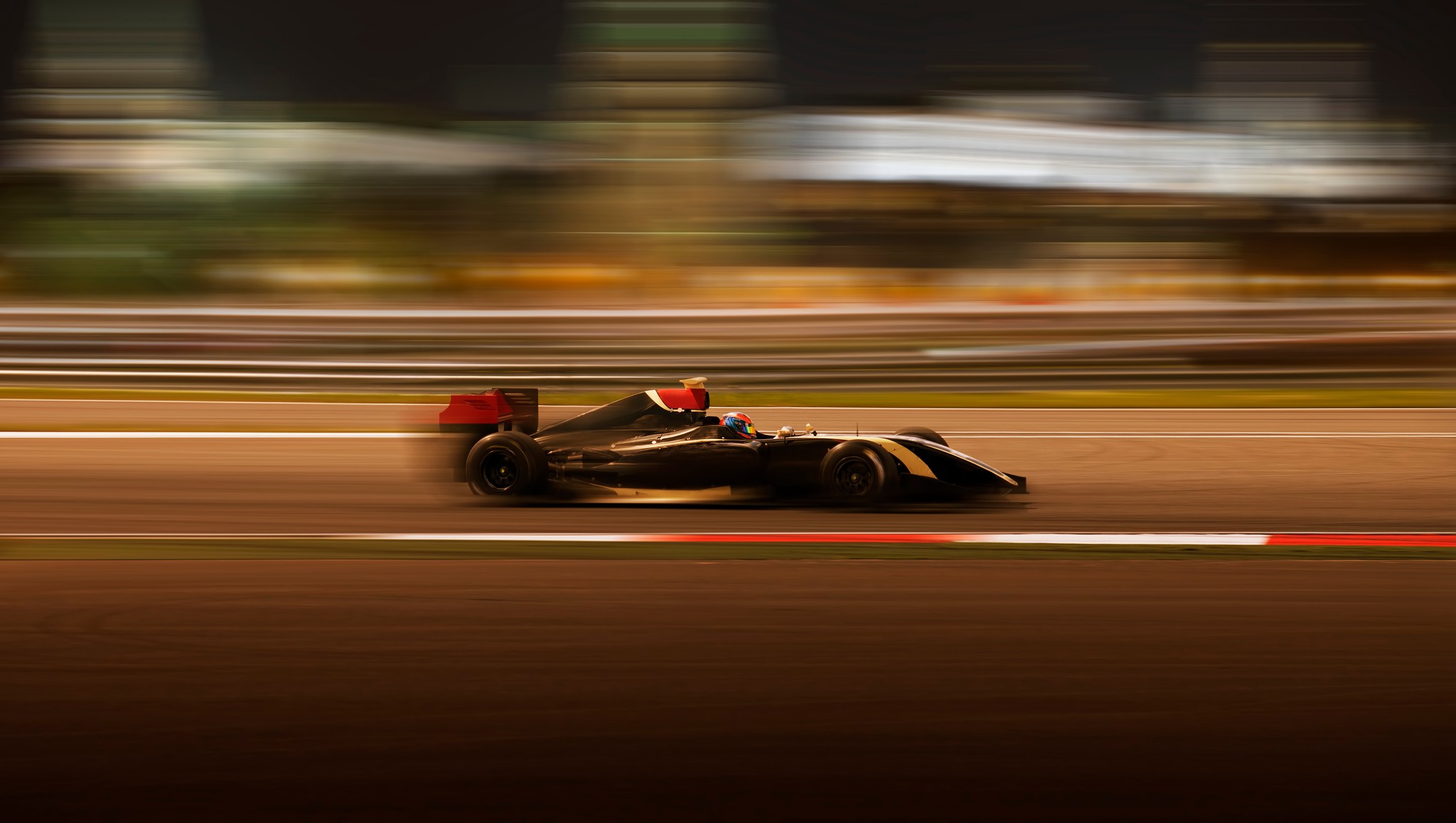 A black racing car against a motion-blurred track in artwork from Kepler’s Las Vegas Grand Prix case study