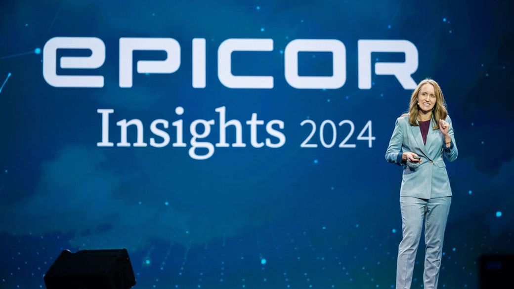 Kerrie Jordan speaking on the blue-lit stage at Epicor Insights 2024